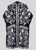 Black embroidered garment with white floral patterns on a light gray background