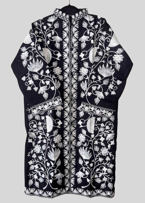 Black embroidered garment with white floral patterns on a light gray background