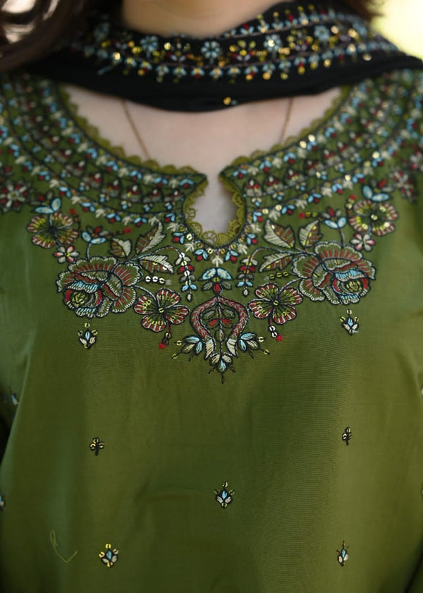 Green embroidered garment with intricate patterns