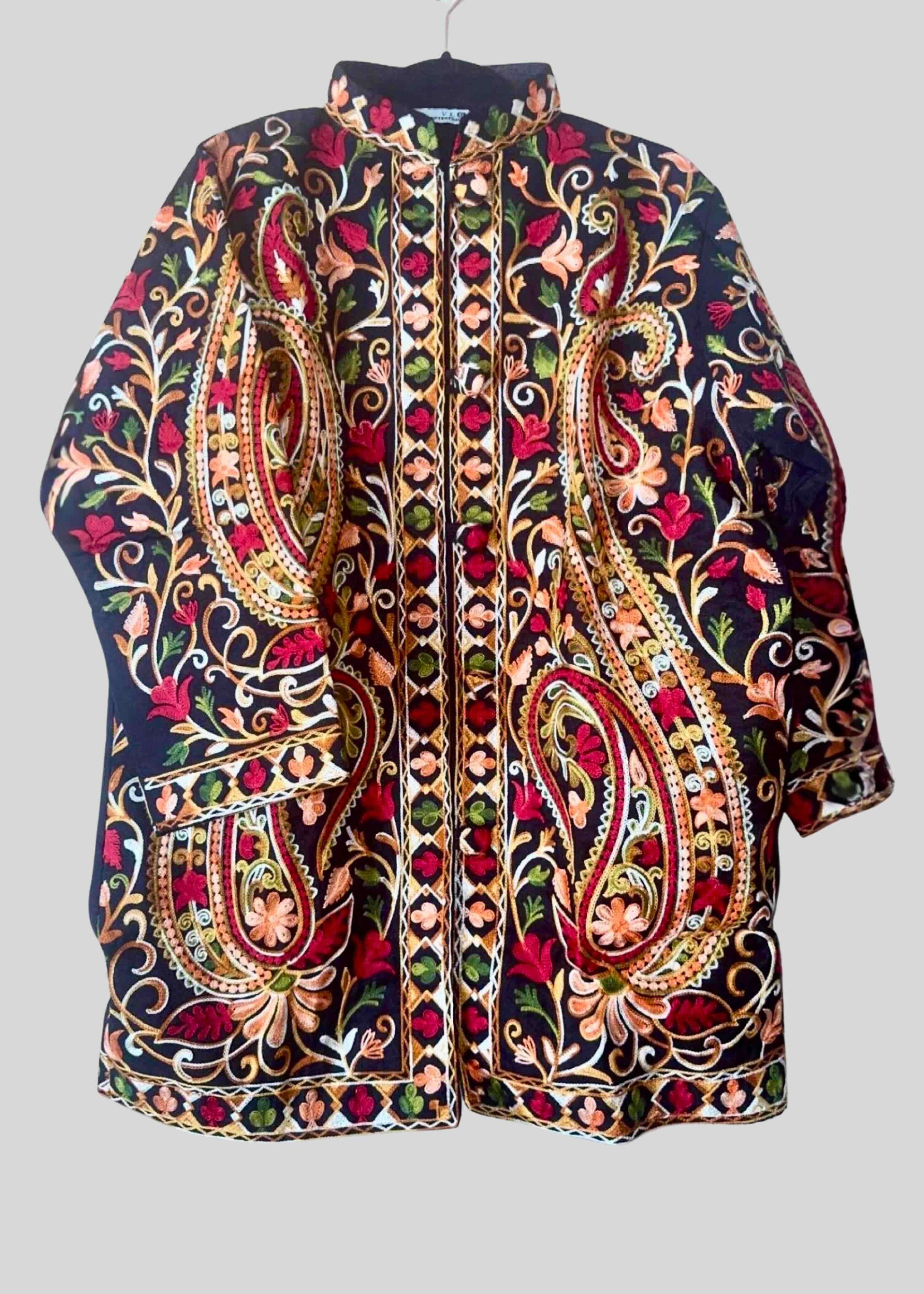 Colorful embroidered jacket on a gray background