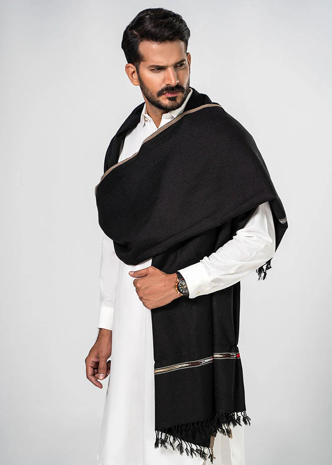 Man wearing a black scarf with gold trim over a white outfit on a light gray background