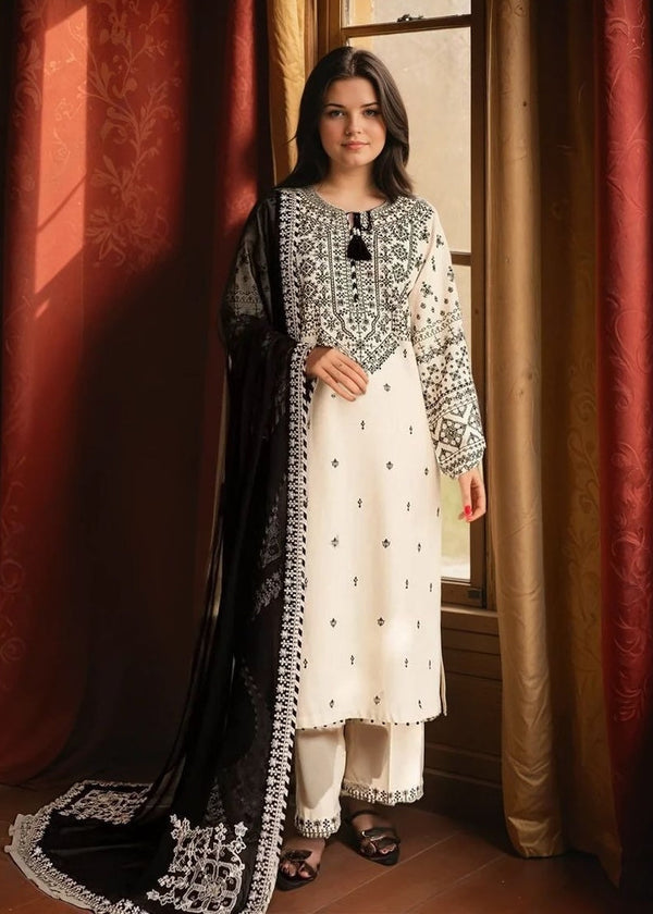 Woman wearing a traditional outfit with black and white embroidery in a room with red curtains.