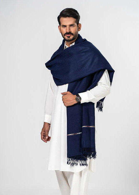 Man wearing a navy blue scarf and white traditional outfit on a white background